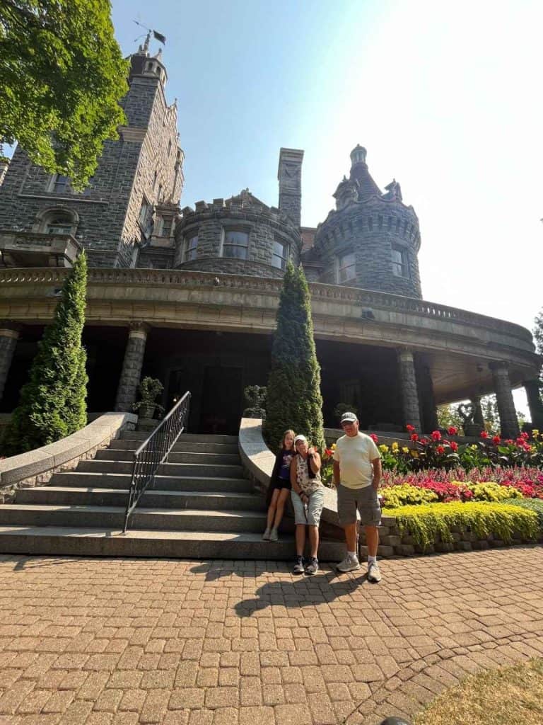 Family photo stop at Boldt Castle during a Thousand Islands 1 Day Itinerary with Kids Grandparents and child in front of Boldt Castle on Heart Island for a Thousand Islands 1 Day Itinerary.
