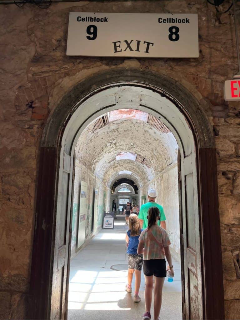A family walking through the Eastern State Penitentiary (prison) in Philadelphia.